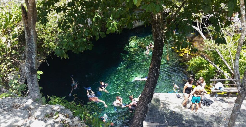 Traveler Swimming El Gran Cenote in Tulum, Mexico