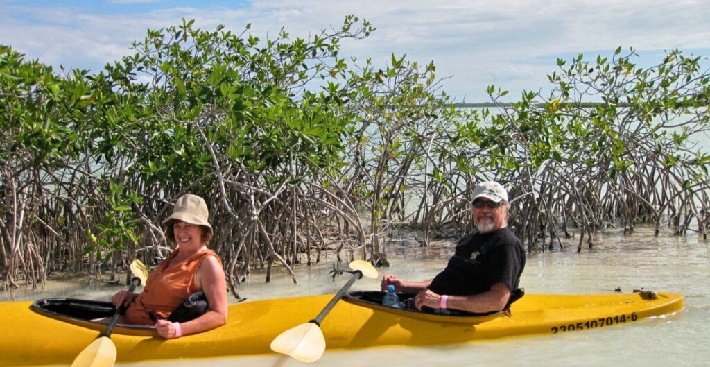 Middle-aged couple kayaking in Sian Ka’an Biosphere Reserve tulum, Mexico